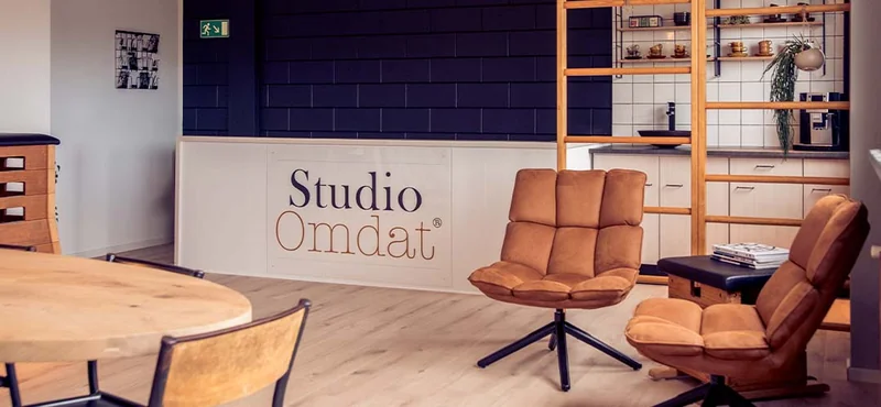 De ontvangstruimte van Studio Omdat met het logo op de wand